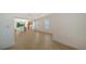 Open living room offers hardwood floors, lots of natural light, and a seamless transition to the kitchen at 10105 Canaveral Cir, Sarasota, FL 34241