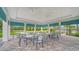 Outdoor seating area with multiple tables and chairs with a view of the pool area at 10105 Canaveral Cir, Sarasota, FL 34241
