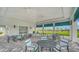 Outdoor seating area with multiple tables and chairs, a partial view of palm trees at 10105 Canaveral Cir, Sarasota, FL 34241