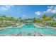 Large community pool with sun loungers and tropical landscaping at 10105 Canaveral Cir, Sarasota, FL 34241