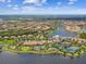 Breathtaking aerial view showcasing a community with lakes, pools, tennis courts and beautiful homes with terracotta roofs at 10205 Saint Francis Ter, Palmetto, FL 34221