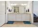 Bathroom with double sink vanity, large mirror and tiled floor, providing a modern and clean aesthetic at 10205 Saint Francis Ter, Palmetto, FL 34221