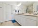 Bright bathroom featuring a double vanity and a large mirror, creating a spacious feel at 10205 Saint Francis Ter, Palmetto, FL 34221