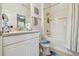Bright bathroom featuring vanity, toilet, tub-shower combo with tile and stone details at 10205 Saint Francis Ter, Palmetto, FL 34221