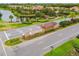 Community entrance with Artisan Lakes sign, beautifully landscaped areas, and scenic pond views at 10205 Saint Francis Ter, Palmetto, FL 34221