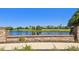 Scenic community pond with brick retaining wall, lush greenery, and neighborhood views at 10205 Saint Francis Ter, Palmetto, FL 34221