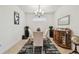 Elegant dining room with a glass table, stylish chandelier, and decorative accents at 10205 Saint Francis Ter, Palmetto, FL 34221
