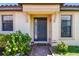 Inviting front entrance showcasing an elegant door, complemented by manicured landscaping and decorative exterior lighting at 10205 Saint Francis Ter, Palmetto, FL 34221