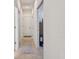Bright hallway with tile floors leads to various rooms, showcasing the home's layout and access at 10205 Saint Francis Ter, Palmetto, FL 34221