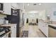 Modern kitchen featuring stainless steel appliances and a view into the dining room at 10205 Saint Francis Ter, Palmetto, FL 34221