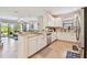 Spacious kitchen with white cabinets, stainless appliances, and an open view to the living area at 10205 Saint Francis Ter, Palmetto, FL 34221