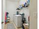 Practical laundry room with washer and dryer, shelfing and a rug, making laundry convenient at 10205 Saint Francis Ter, Palmetto, FL 34221