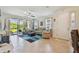 Bright living room boasts tile floors, neutral furniture, and a seamless transition to outdoor living space at 10205 Saint Francis Ter, Palmetto, FL 34221