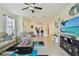 Inviting living room open to the kitchen, with a comfortable sofa and entertainment center at 10205 Saint Francis Ter, Palmetto, FL 34221