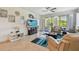 This is a well-lit living room with comfortable seating and a view to the outdoor patio space at 10205 Saint Francis Ter, Palmetto, FL 34221