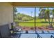 Covered outdoor patio offers a peaceful view of the landscaped lawn and blue skies at 10205 Saint Francis Ter, Palmetto, FL 34221