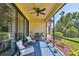 Relaxing screened-in patio featuring comfortable seating and a ceiling fan, perfect for outdoor living at 10205 Saint Francis Ter, Palmetto, FL 34221