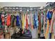 Organized walk-in closet with shelves and hanging rods for ample storage, maximizing space at 10205 Saint Francis Ter, Palmetto, FL 34221