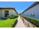 A stone walkway meanders between homes, lined with lush greenery and leading to tranquility and privacy at 10205 Saint Francis Ter, Palmetto, FL 34221