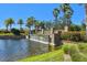 Charming brick and stone water feature with cascading waterfall into a serene community lake at 10205 Saint Francis Ter, Palmetto, FL 34221