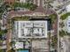 Aerial view of a luxurious building with a rooftop terrace, offering stunning views of the surrounding area at 111 Golden Gate Pt # 802Ph, Sarasota, FL 34236