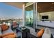 Relaxing balcony featuring comfortable seating and stunning views of the water and city skyline at 111 Golden Gate Pt # 802Ph, Sarasota, FL 34236