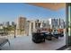 Inviting balcony with comfortable seating and picturesque views of the city skyline at 111 Golden Gate Pt # 802Ph, Sarasota, FL 34236