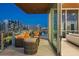 Serene balcony with plush seating and sparkling city night views at 111 Golden Gate Pt # 802Ph, Sarasota, FL 34236