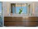 Vanity with double sinks, large mirrors, and ample storage in modern bathroom at 111 Golden Gate Pt # 802Ph, Sarasota, FL 34236