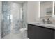 Modern bathroom featuring a marble-tiled walk-in shower, sleek vanity, and contemporary fixtures and finishes at 111 Golden Gate Pt # 802Ph, Sarasota, FL 34236
