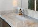 Bathroom sink and marble countertop offer a sleek and modern design at 111 Golden Gate Pt # 802Ph, Sarasota, FL 34236