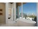 Elegant bathroom with a freestanding tub and a large window showcasing city views at 111 Golden Gate Pt # 802Ph, Sarasota, FL 34236