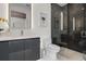 Modern bathroom with a sleek vanity, toilet, and a walk-in shower with dark marble-like tiles at 111 Golden Gate Pt # 802Ph, Sarasota, FL 34236
