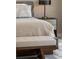Cozy bedroom featuring neutral tones and a modern bench seat at the foot of the bed at 111 Golden Gate Pt # 802Ph, Sarasota, FL 34236