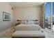 Serene bedroom with neutral tones, plush bedding, and a large window overlooking the city at 111 Golden Gate Pt # 802Ph, Sarasota, FL 34236