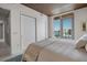 Inviting bedroom boasting natural light, a spacious closet, wood ceilings and a scenic view from the balcony at 111 Golden Gate Pt # 802Ph, Sarasota, FL 34236