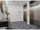 Hallway with elevators, a decorative mirror and table, and stylish flooring, adding character to the space at 111 Golden Gate Pt # 802Ph, Sarasota, FL 34236