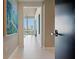Bright hallway with tiled floor, modern artwork, and expansive windows offering city views at 111 Golden Gate Pt # 802Ph, Sarasota, FL 34236