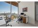 Modern home office with two workstations, large windows offering city views, and comfortable ergonomic chairs at 111 Golden Gate Pt # 802Ph, Sarasota, FL 34236