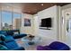 Inviting living room with comfortable seating and city views from a large window, creating a relaxing space at 111 Golden Gate Pt # 802Ph, Sarasota, FL 34236