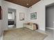 Contemporary living room featuring a comfortable sofa, abstract art, and access to a modern bathroom at 111 Golden Gate Pt # 802Ph, Sarasota, FL 34236