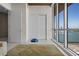 Bright living room with stunning water views, modern rug, and access to a private balcony at 111 Golden Gate Pt # 802Ph, Sarasota, FL 34236