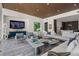 Contemporary living room with stylish furniture, wood ceiling, and open layout to the kitchen at 111 Golden Gate Pt # 802Ph, Sarasota, FL 34236