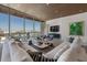 Bright living room featuring floor-to-ceiling windows with views of the marina and city skyline at 111 Golden Gate Pt # 802Ph, Sarasota, FL 34236
