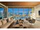 Spacious living room with expansive windows showcasing stunning city and harbor views at 111 Golden Gate Pt # 802Ph, Sarasota, FL 34236