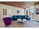 Bright living room featuring wood ceilings, stylish decor, and a large window with city views at 111 Golden Gate Pt # 802Ph, Sarasota, FL 34236