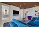Living room boasts stylish wood ceilings, modern decor, and an open layout for seamless entertaining at 111 Golden Gate Pt # 802Ph, Sarasota, FL 34236