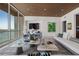 Elegant living room featuring modern decor, large windows with water views, and open-concept design at 111 Golden Gate Pt # 802Ph, Sarasota, FL 34236