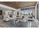 Open-concept living room featuring a large sectional sofa and a panoramic view of the water at 111 Golden Gate Pt # 802Ph, Sarasota, FL 34236