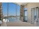 Bright bedroom with floor-to-ceiling windows offering breathtaking views of the bay and city at 111 Golden Gate Pt # 802Ph, Sarasota, FL 34236
